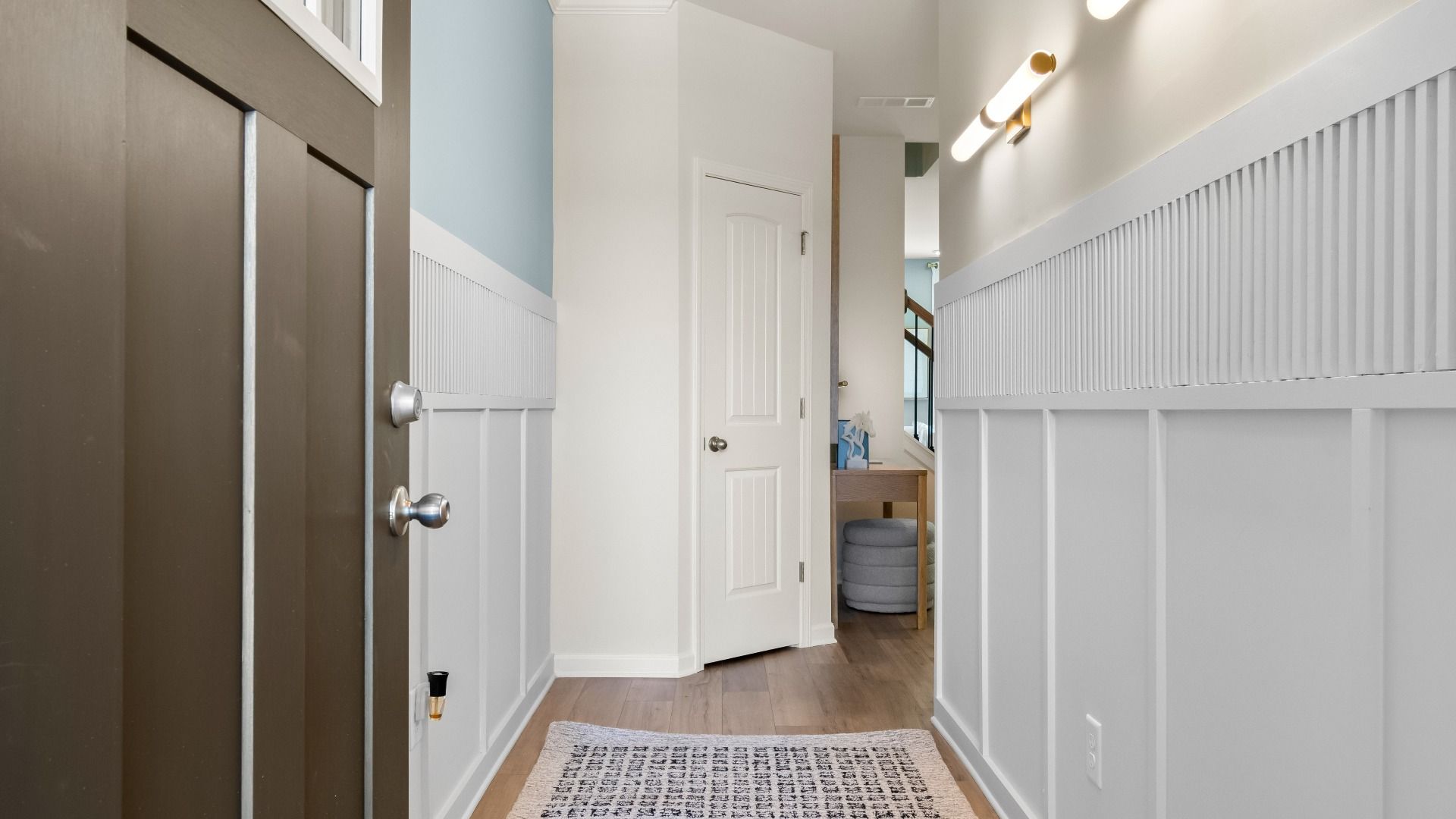 Inviting entryway of new construction townhome featuring stylish trim and modern entry design.