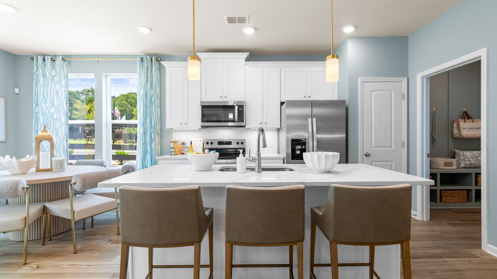 Modern kitchen in new construction townhome with large island, quartz countertops, and stainless appliances.
