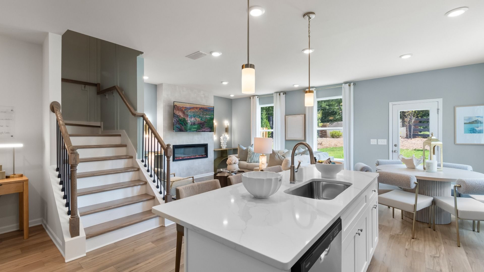 Open concept kitchen and family room in new construction townhome with seamless flow and natural light.