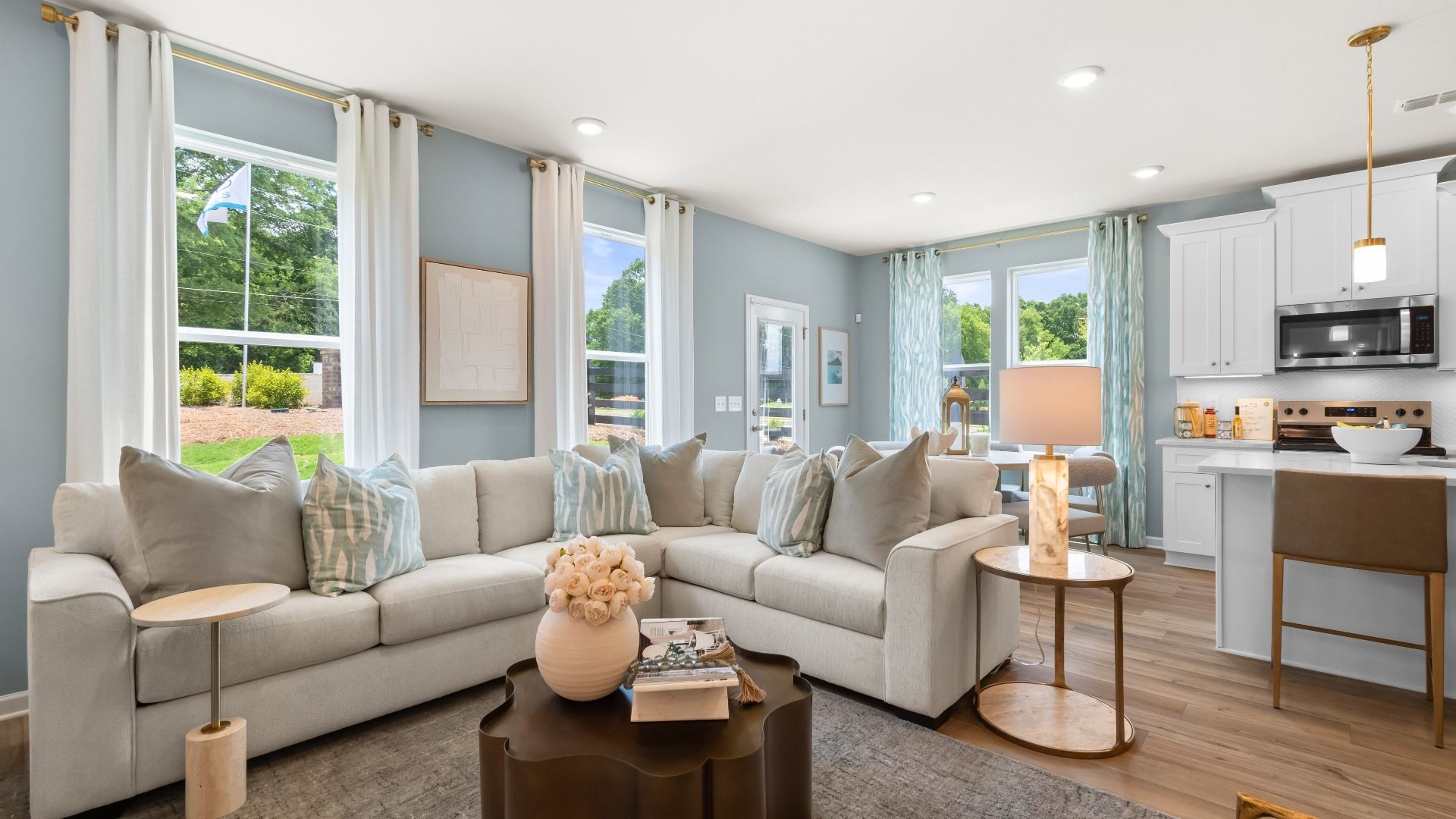 Open concept kitchen and family room in new construction townhome with seamless flow and natural light.