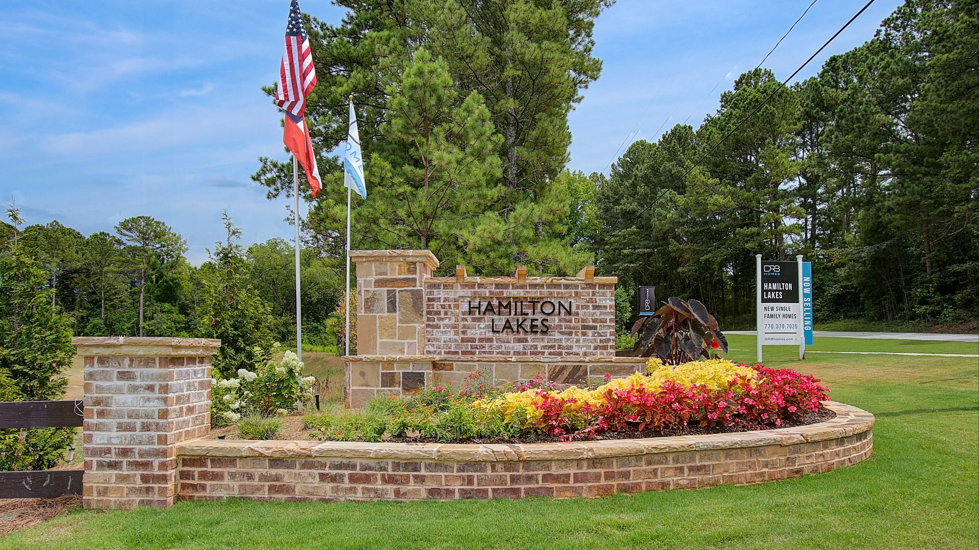 Stone monument entrance sign for Hamilton Lakes single-family home community in Lawrenceville, GA.