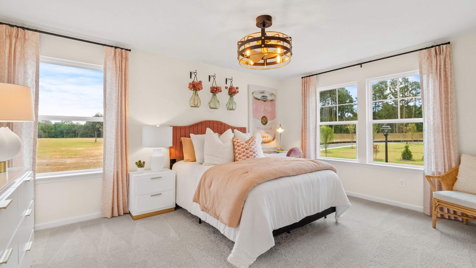 Secondary bedroom with neutral interior design, natural light, and carpeted floors in Hamilton Lakes new construction home.