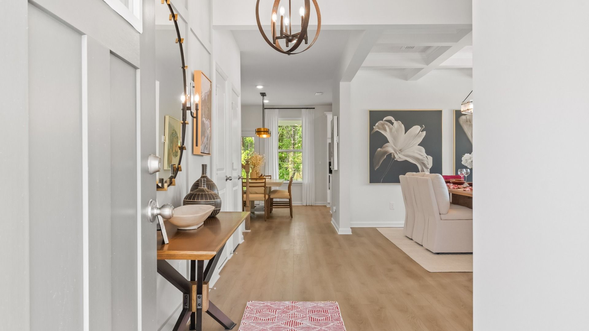 Welcoming entry with white front door and LVP flooring in the Wynwood plan at Abbotts Crossing in Conyers, GA.