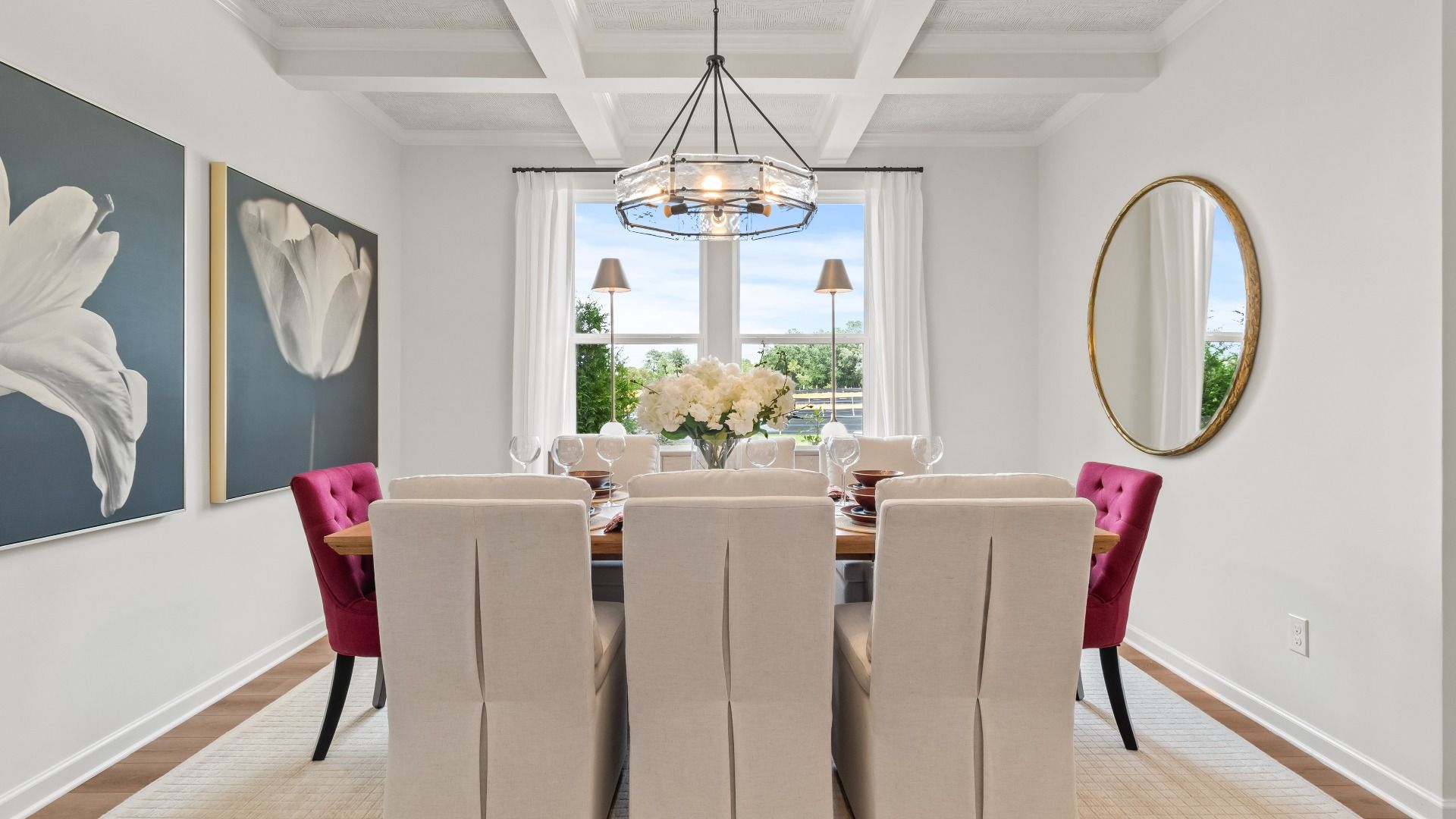 Elegant dining room with coffered ceiling, LVP flooring, and large window in the Wynwood at Abbotts Crossing.