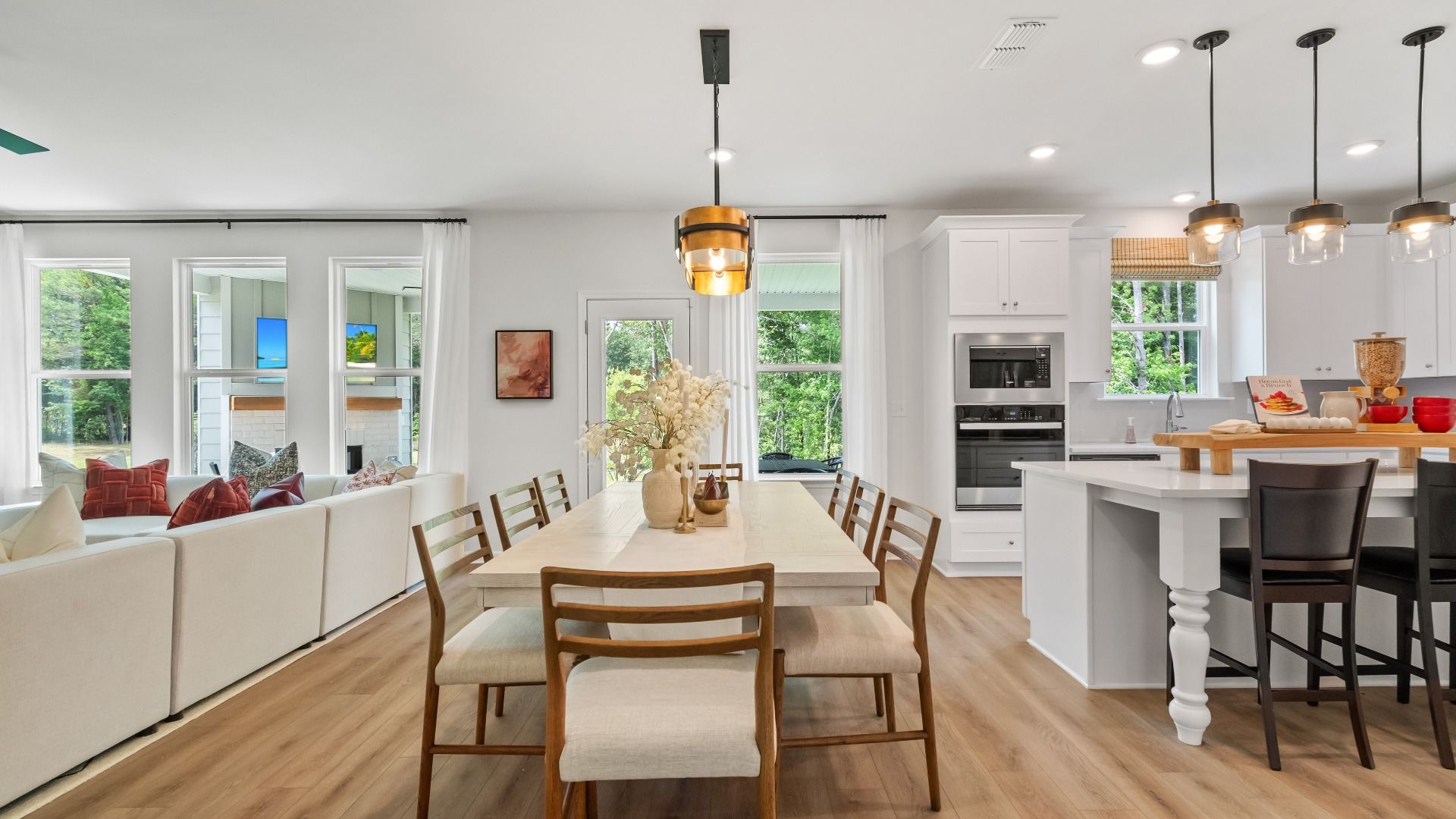 Wynwood open concept main floor with spacious breakfast area and LVP flooring at Abbotts Crossing in Conyers, GA.