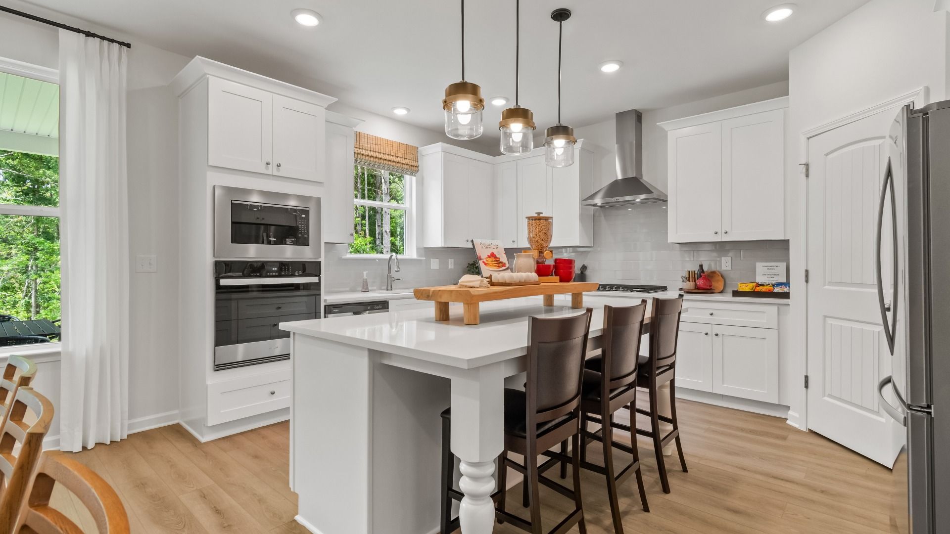 Wynwood kitchen with center island and white modern features at Abbotts Crossing in Conyers, GA.