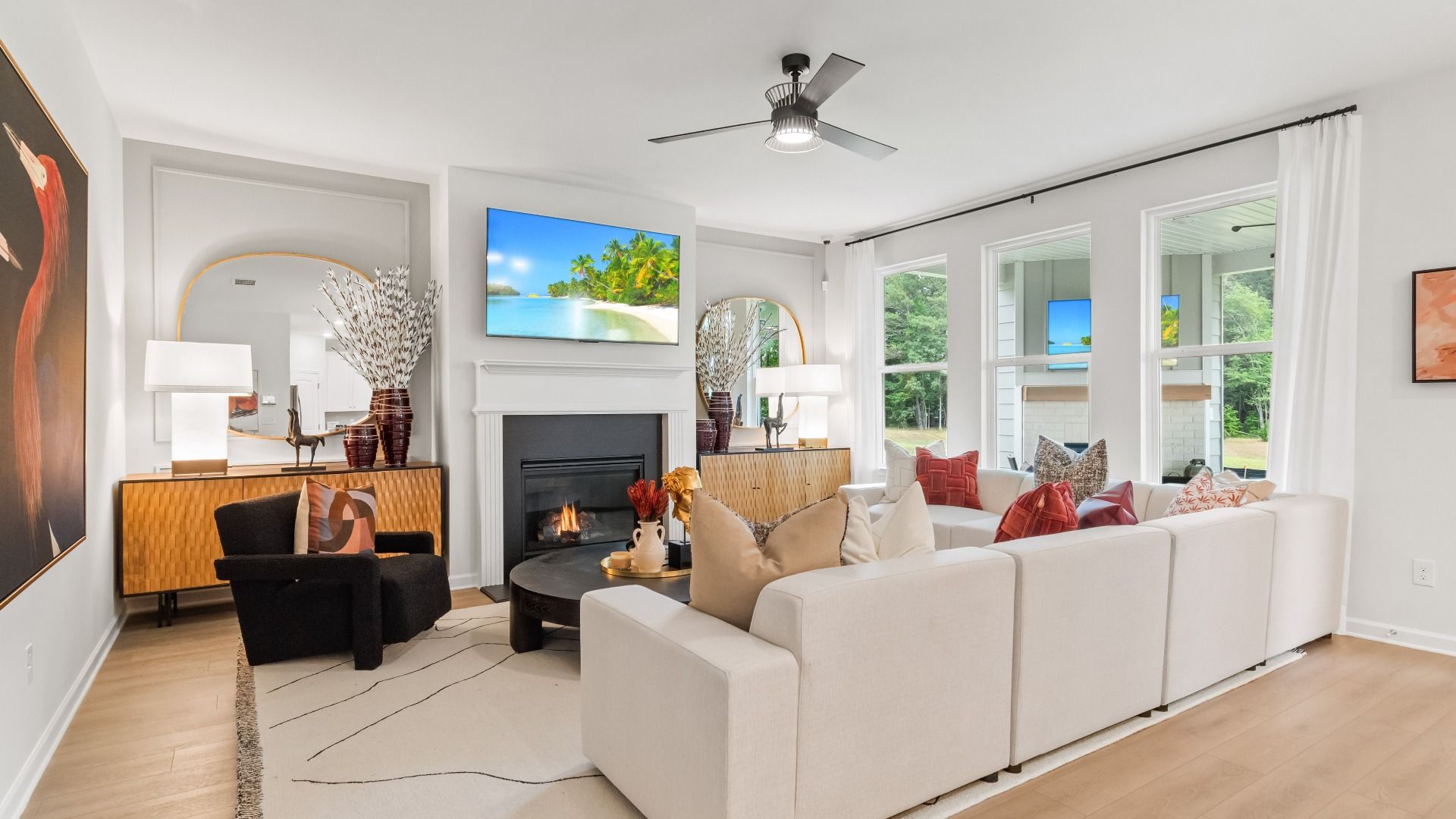 Wynwood family room with ample seating room, large windows, and LVP flooring at Abbotts Crossing in Conyers, GA.
