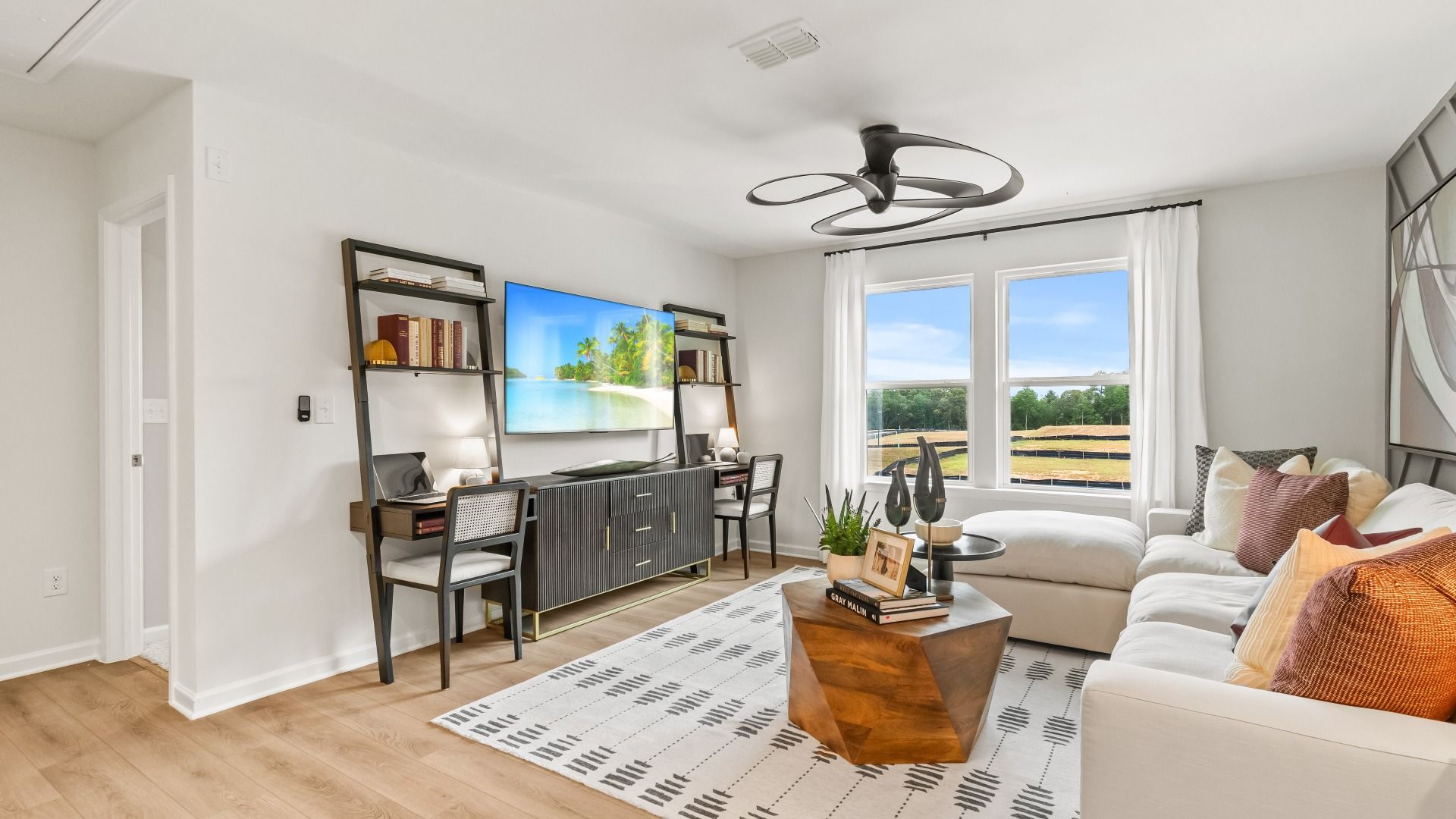 Flexible loft area for work or lounge use with large windows and LVP floorings in the Wynwood plan at Abbotts Crossing.