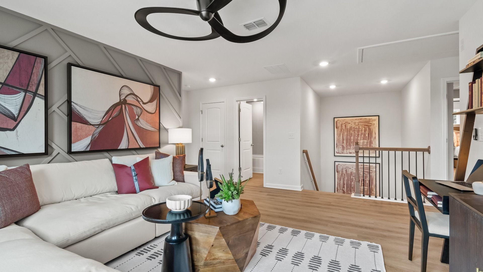 Spacious loft area with room for work, lounge, or play featuring LVP flooring in the Wynwood at Abbotts Crossing.