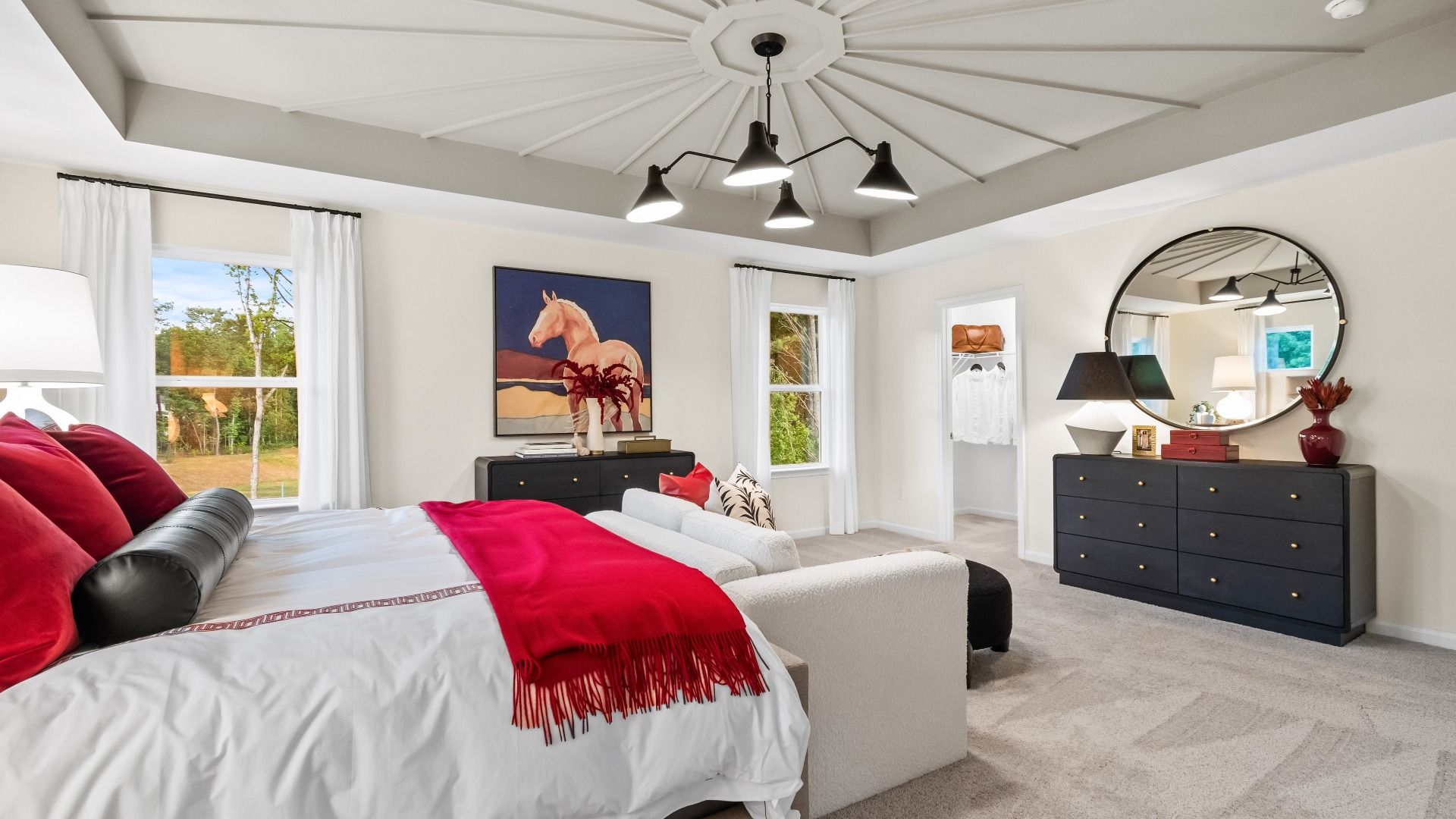 Wynwood primary suite with neutral color palette, carpet flooring, large windows, and tray ceiling at Abbotts Crossing.