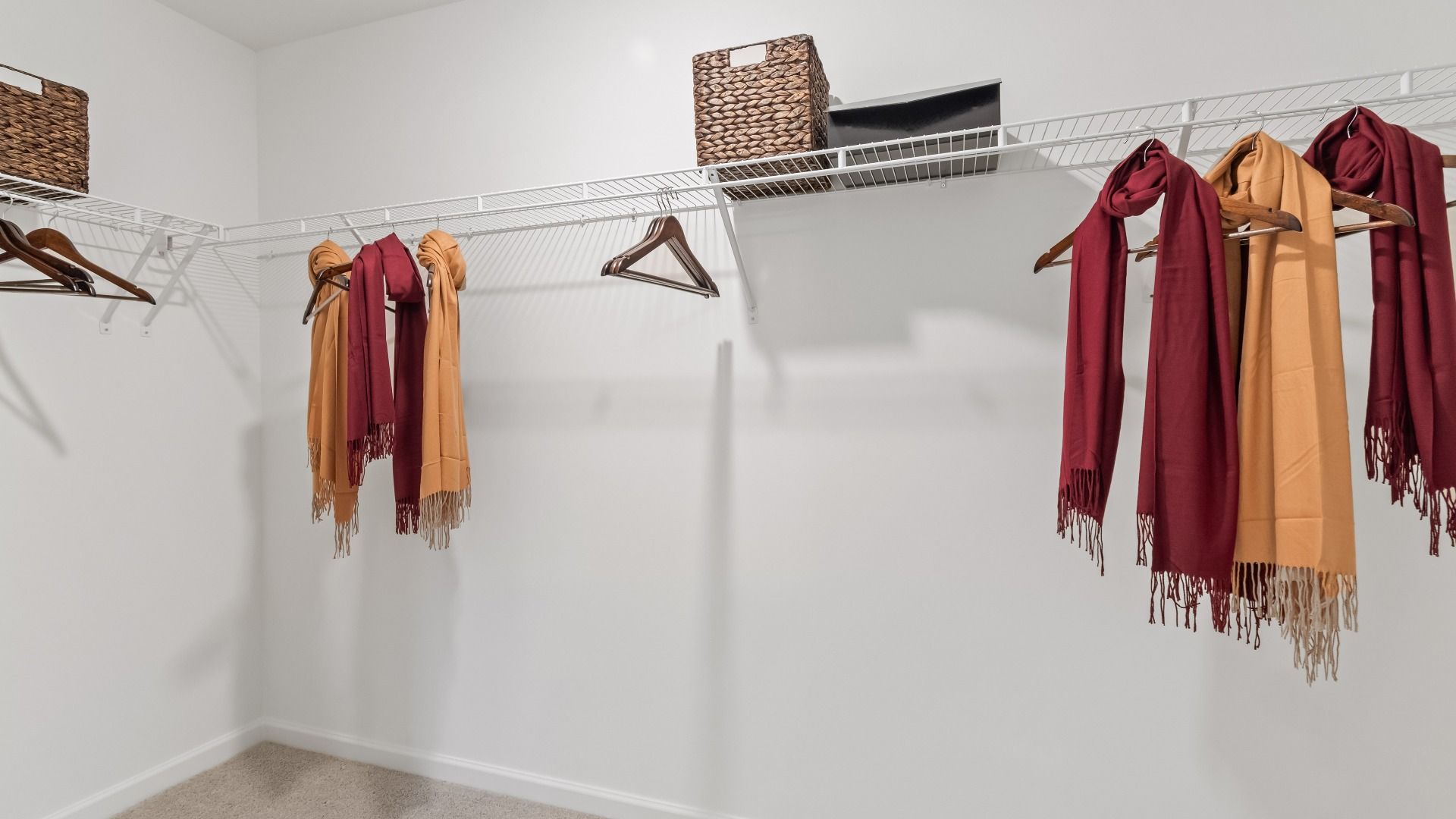 Wynwood primary closet, connecting to primary bath, featuring built-in shelves for organization at Abbotts Crossing.