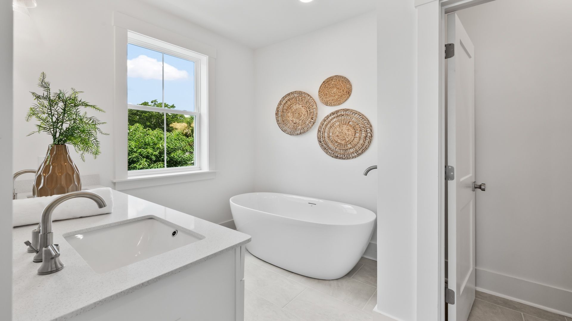 The Sullivan primary bathroom features a soaking tub, modern finishes, and a relaxing design.