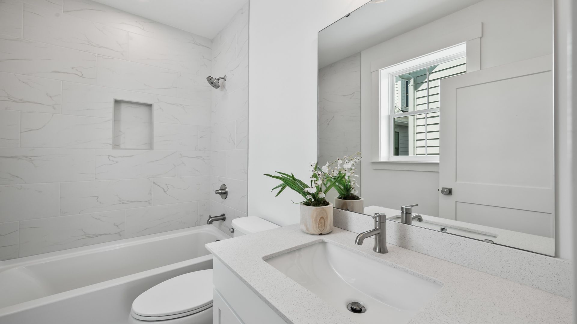 Secondary bathroom in the Sullivan home plan with modern fixtures and bright finishes.