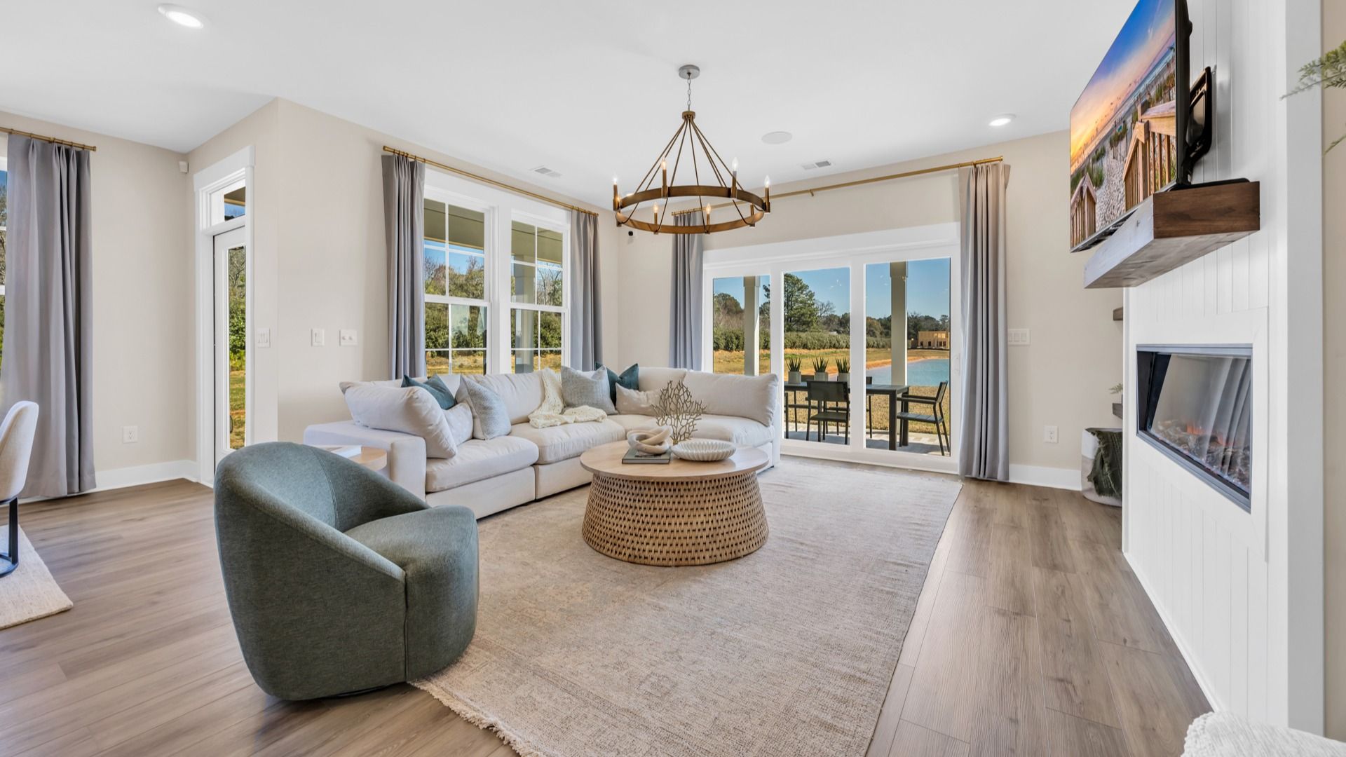 Open concept living room in Chestnut Farms in by DRB homes offering lots of seating and a cozy environment