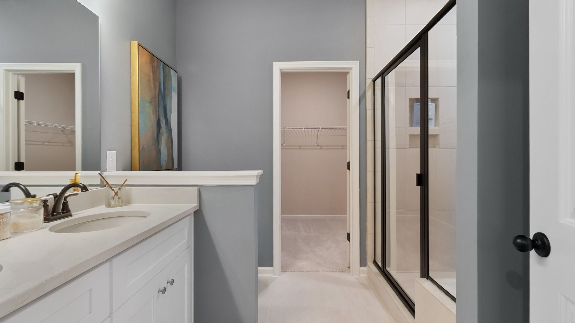 Elegant gray and white bathroom with tiled shower by DRB Homes in Conyers, GA
