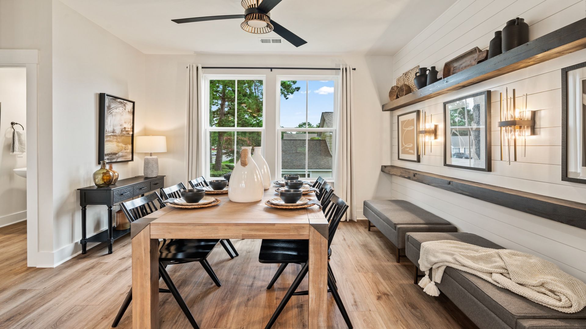 Elegant dining area with built-in shelving and abundant natural light