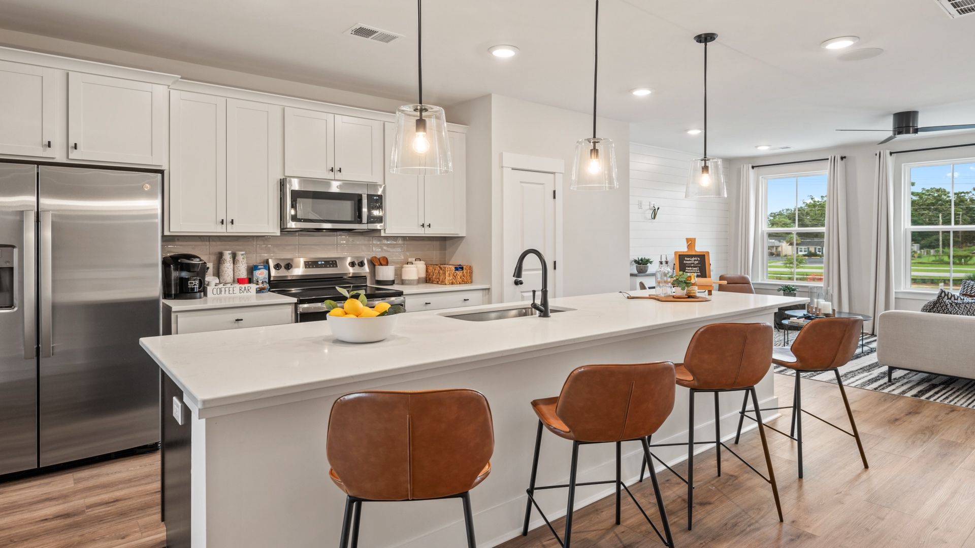 Kitchen island with seating, pendant lights, and open layout