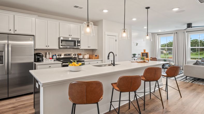 Kitchen island with seating, pendant lights, and open layout