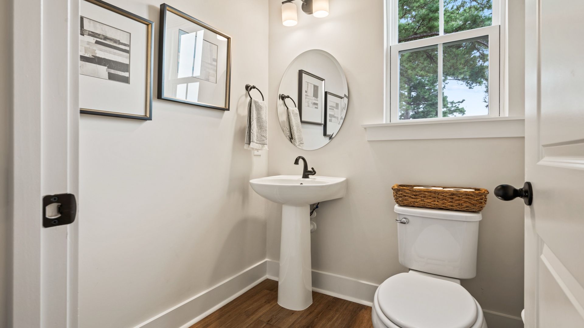 Convenient half bath with pedestal sink off the kitchen