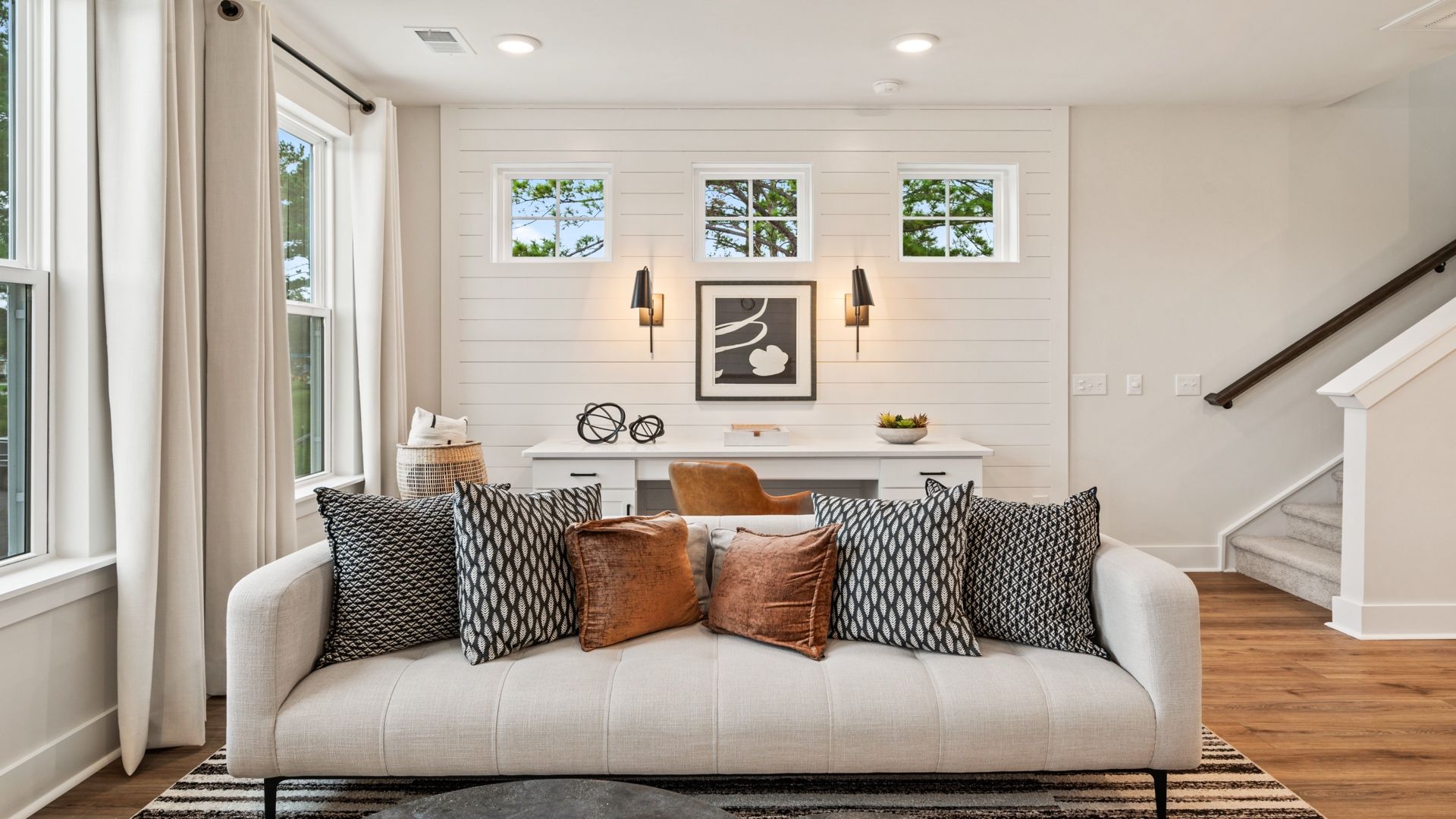 Living room with stairs to third-floor primary suite