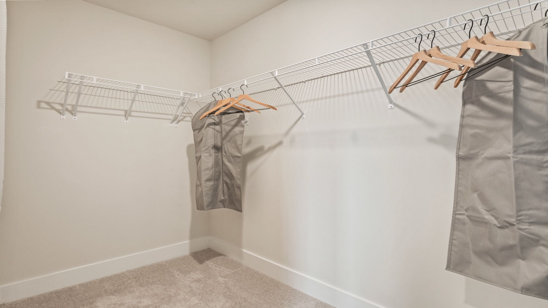 Spacious walk-in closet with built-in shelving in the primary suite