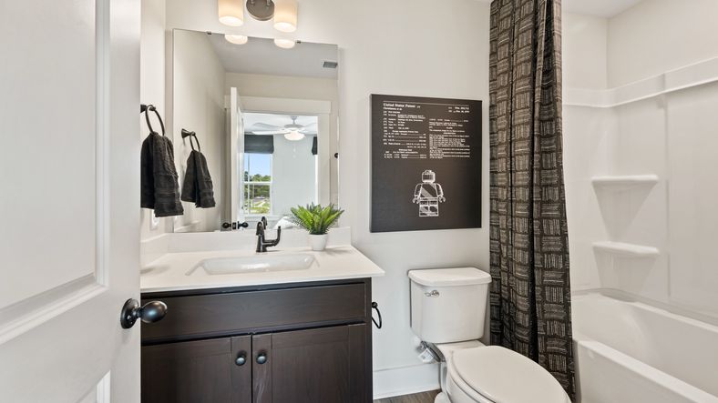 Third-floor bathroom with modern vanity and tub/shower combo