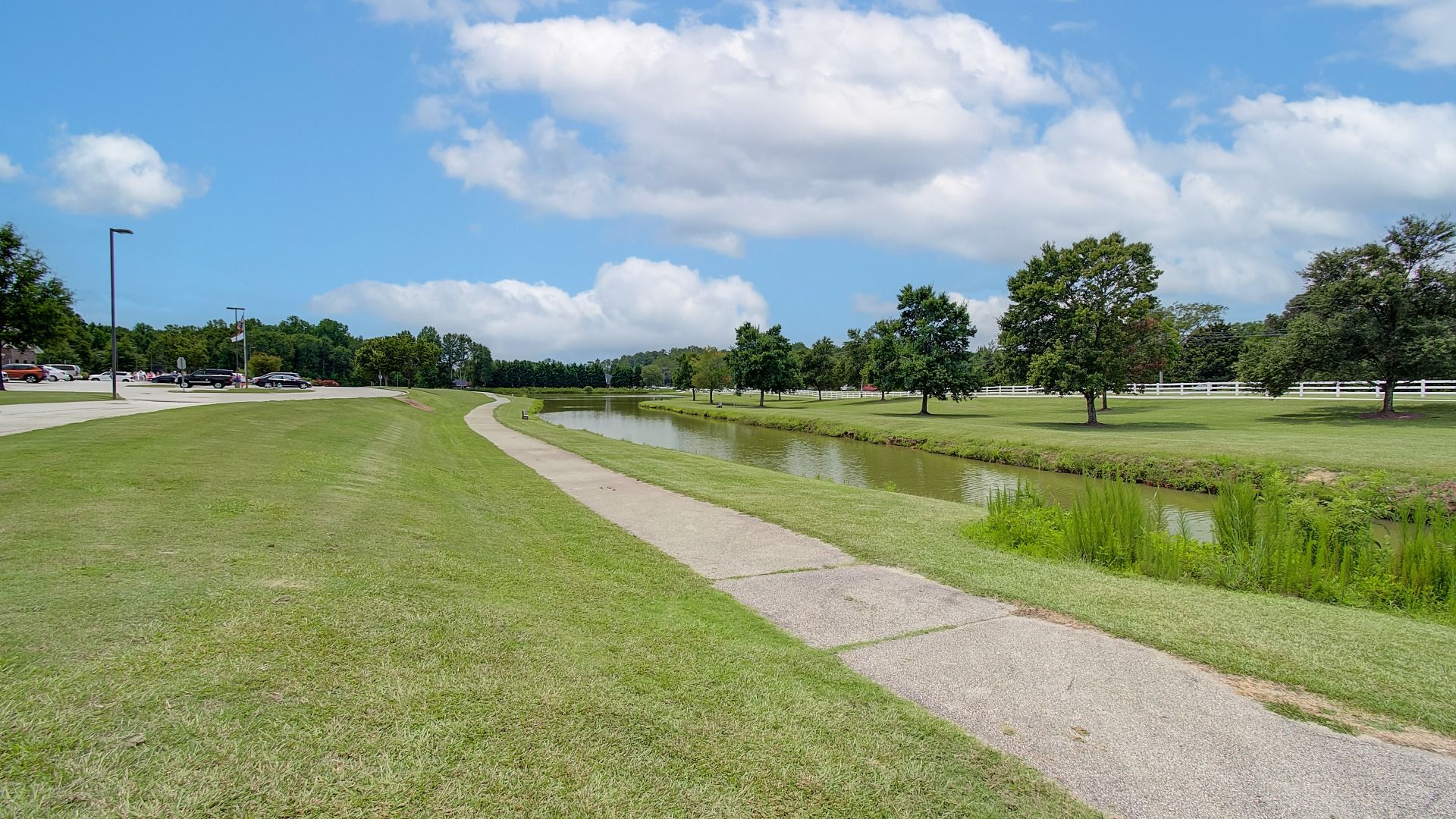 Scenic outdoor walking path with pond view near Northcroft in Loganville, GA.