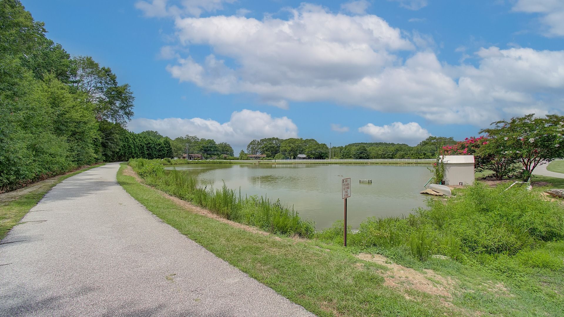 Scenic outdoor walking path with pond view near Northcroft in Loganville, GA.