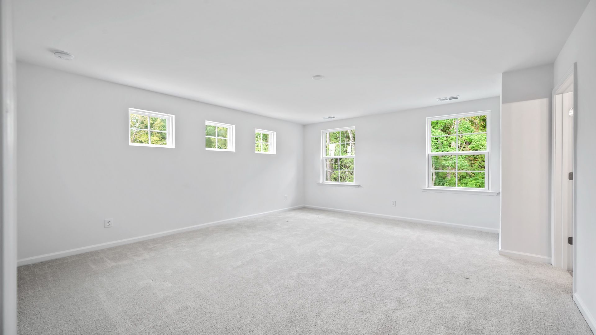 Relax in the bright and airy primary suite of the Pritchard
