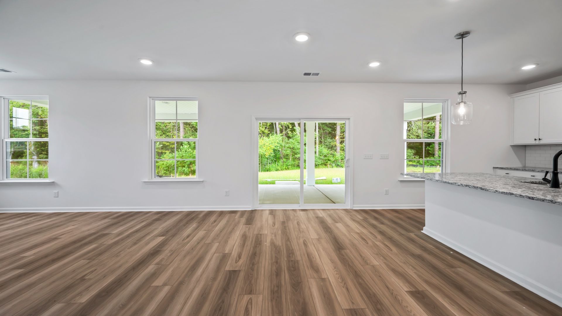 Spacious Pritchard living room with sliding glass door for easy outdoor access