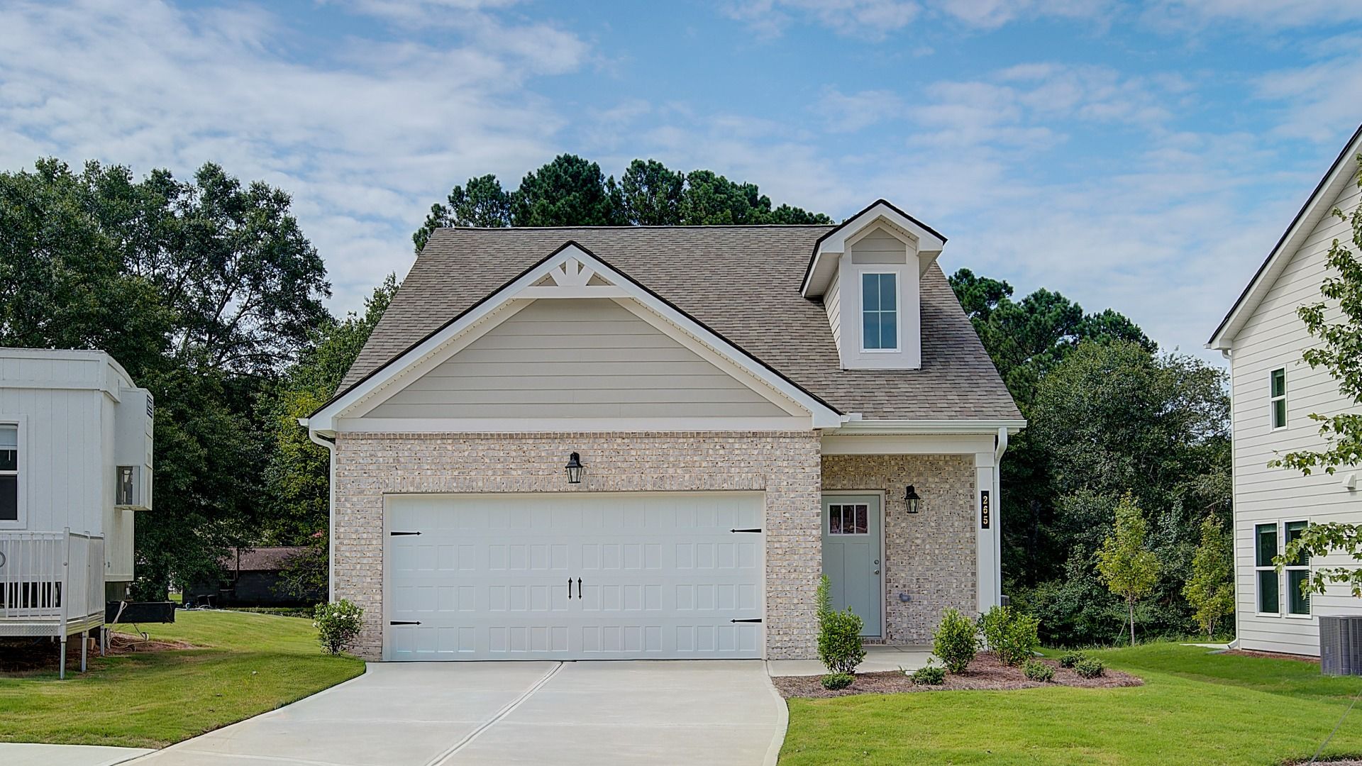 Front exterior of single-family home in Abbotts Crossing with brick and siding façade, manicured lawn, and welcoming entry.