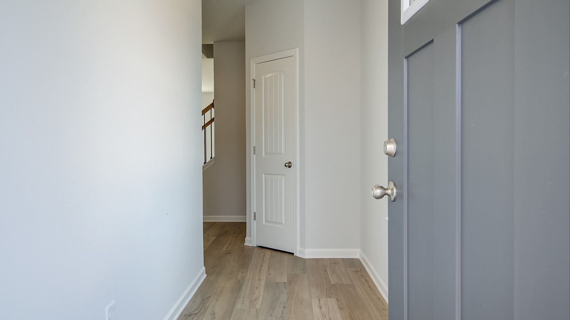 Welcoming interior entryway with high ceilings, coat closet, and open sightlines into main living area.