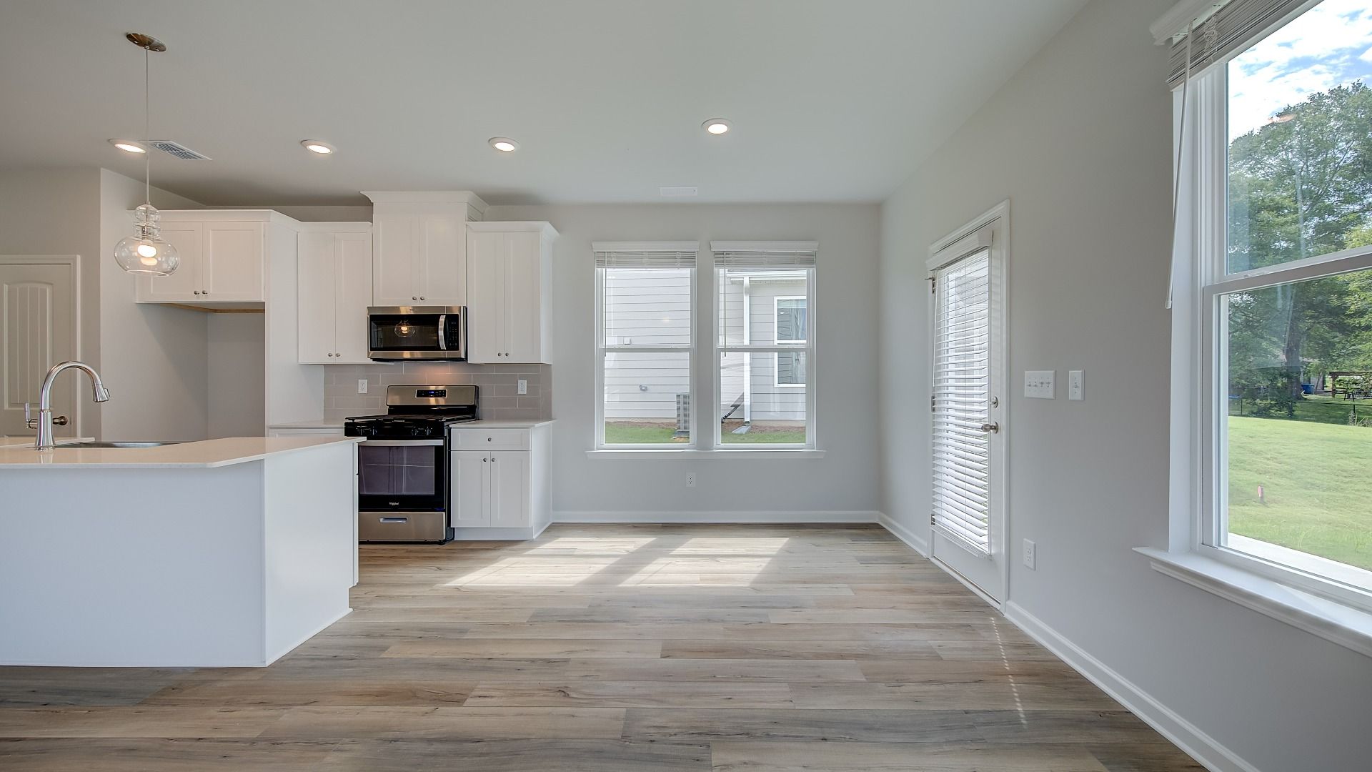 Open breakfast area in new construction townhome with expansive windows and natural light.