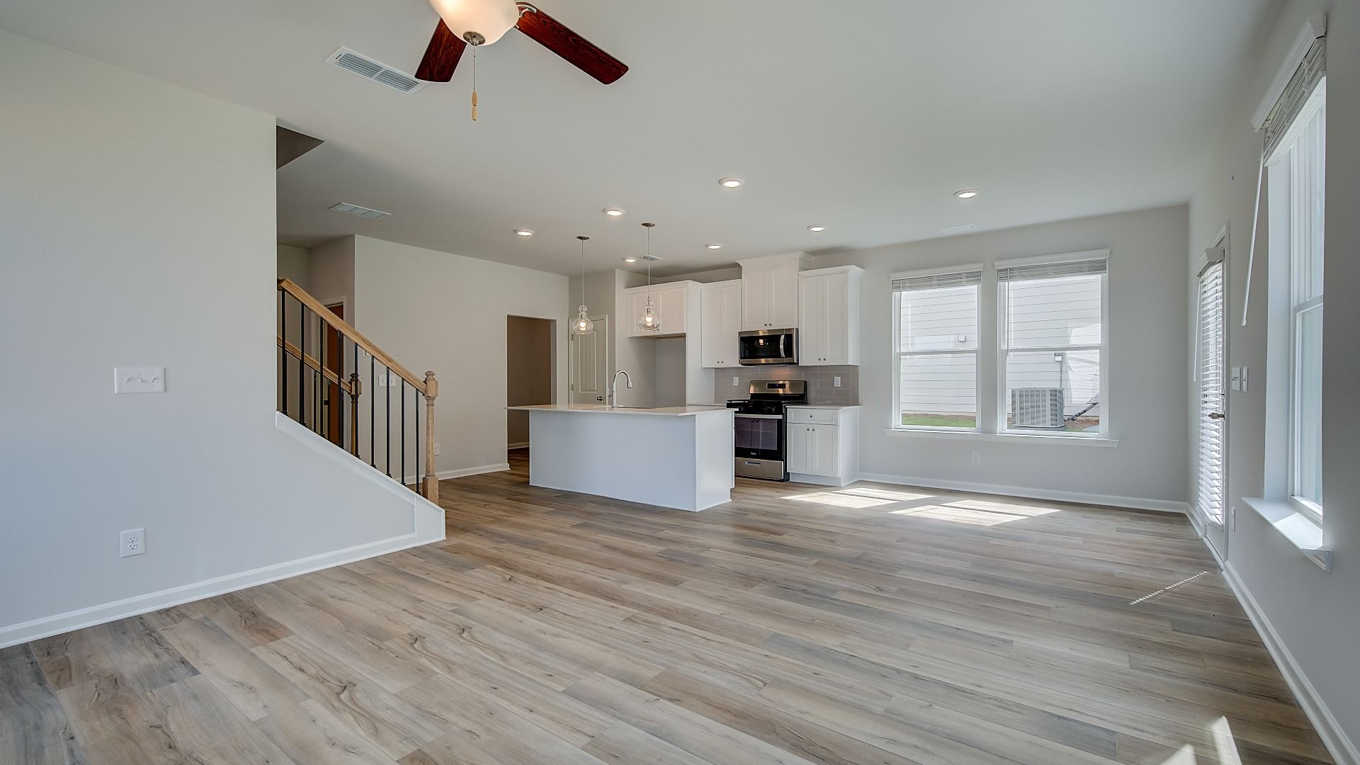 Spacious family room withand open layout and LVP flooring in Conyers, GA home.