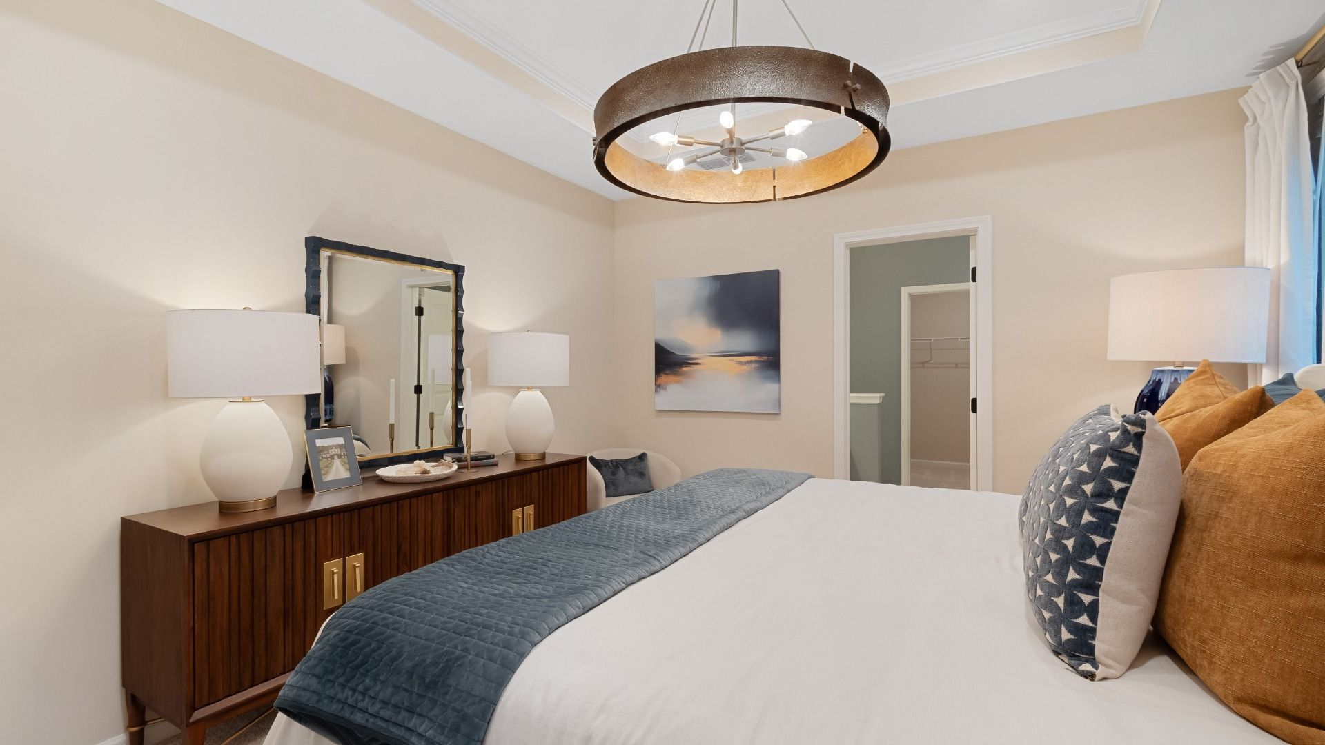 Spacious primary suite with elegant tray ceiling, large windows, and abundant natural light.