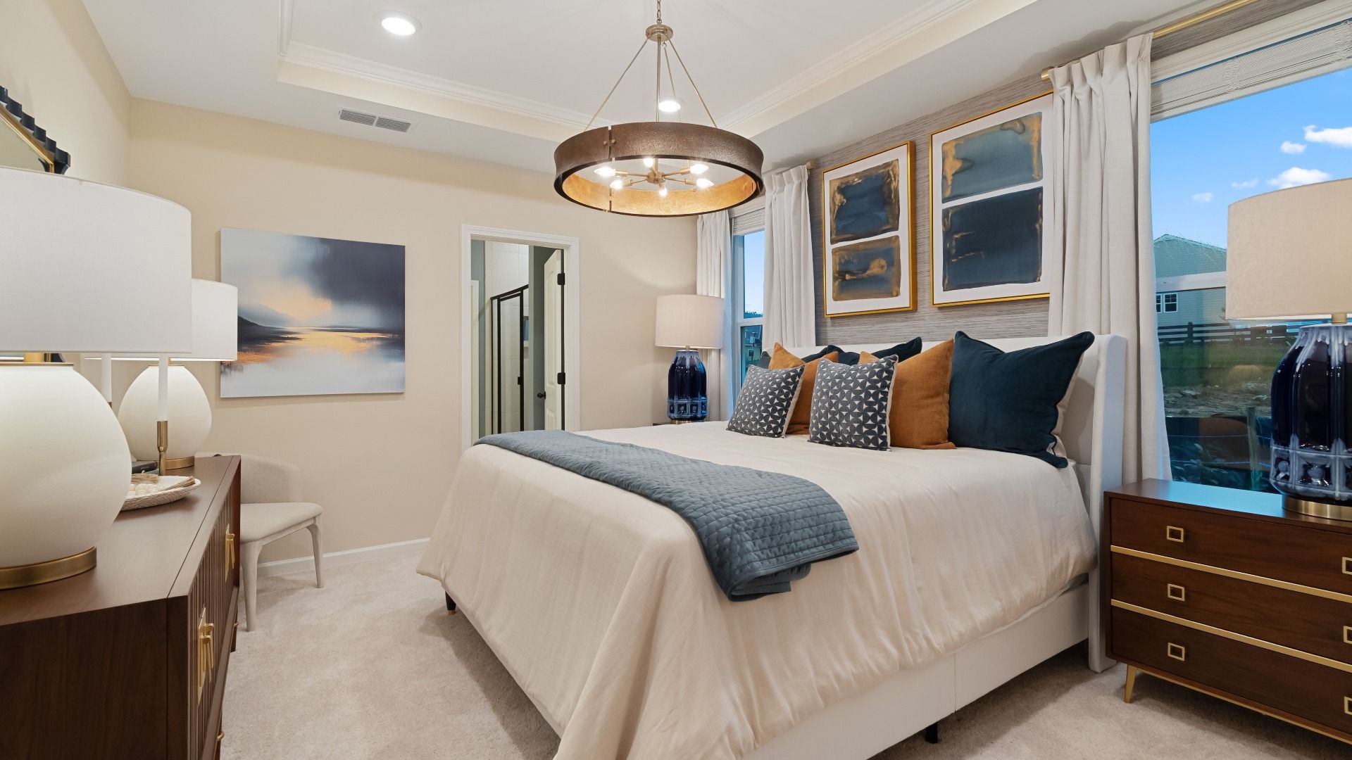 Spacious primary suite with elegant tray ceiling, large windows, and abundant natural light.
