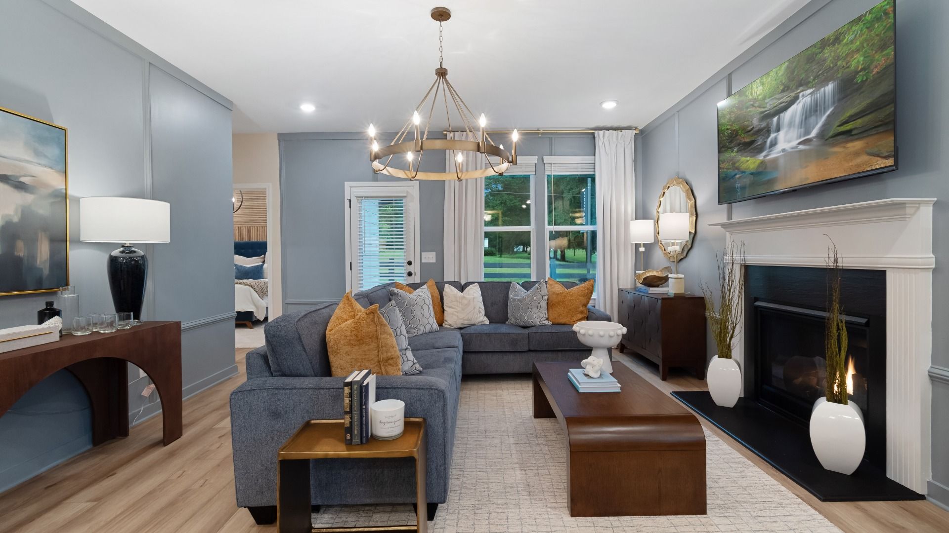 Inviting family room featuring LVP flooring and traditional fireplace with mantel.