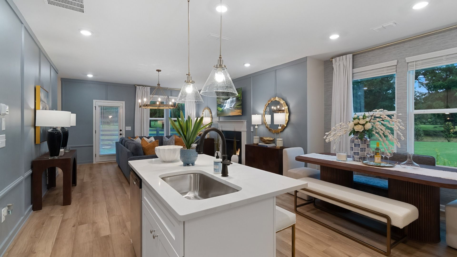 Spacious living area with abundant natural light, neutral walls, and recessed lighting.