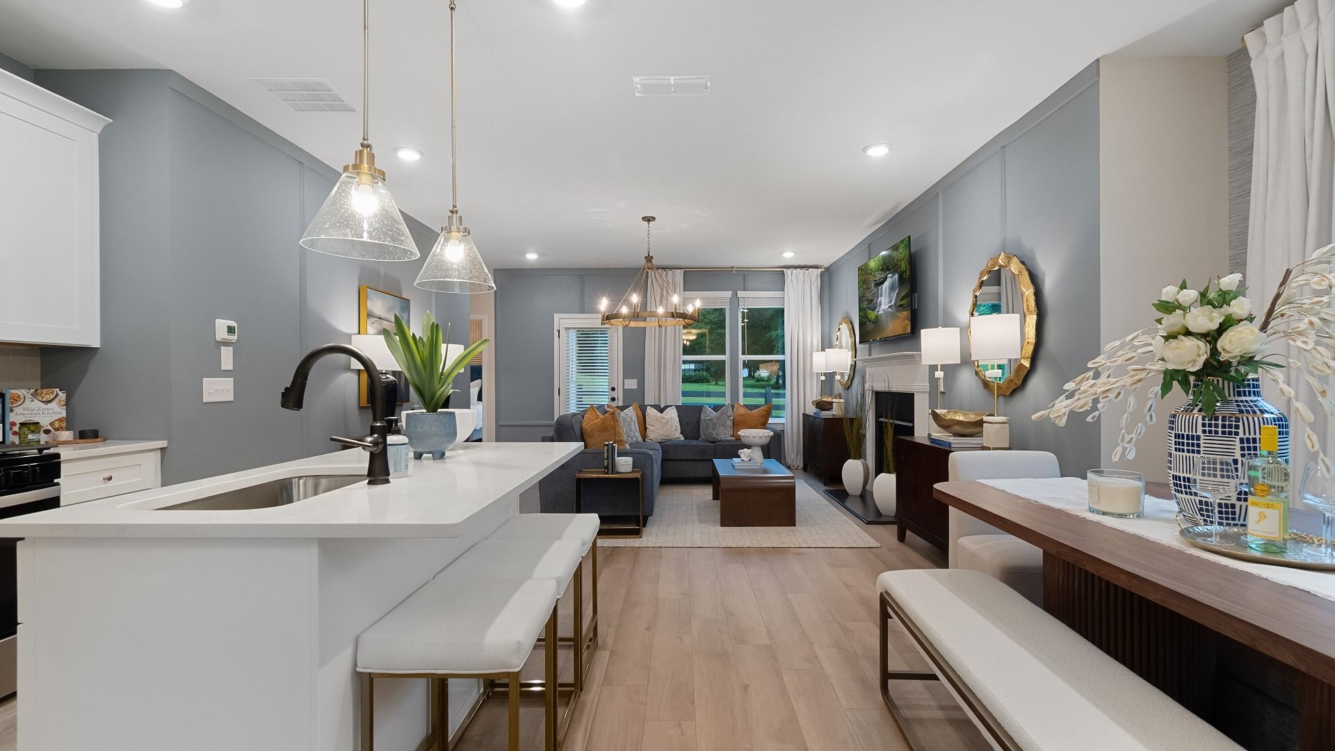 Spacious living area with abundant natural light, neutral walls, and recessed lighting.