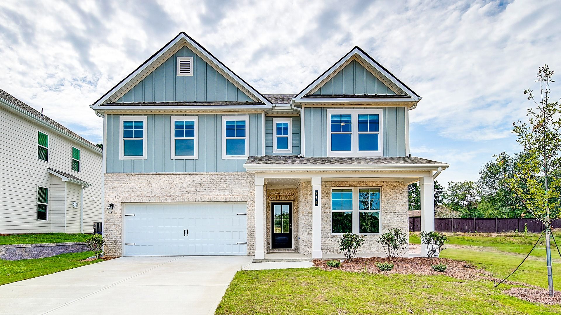 Wagener elevation 2 with first level brick exterior and two-car front-entry garage at Abbotts Crossing.