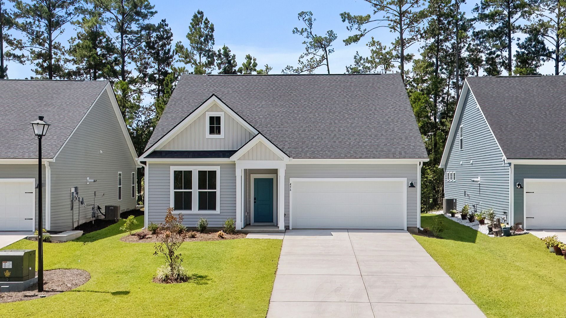 Avondale Exterior at Bluffs at Sun Colony by DRB Homes offering a porch in the front and a two-car garage