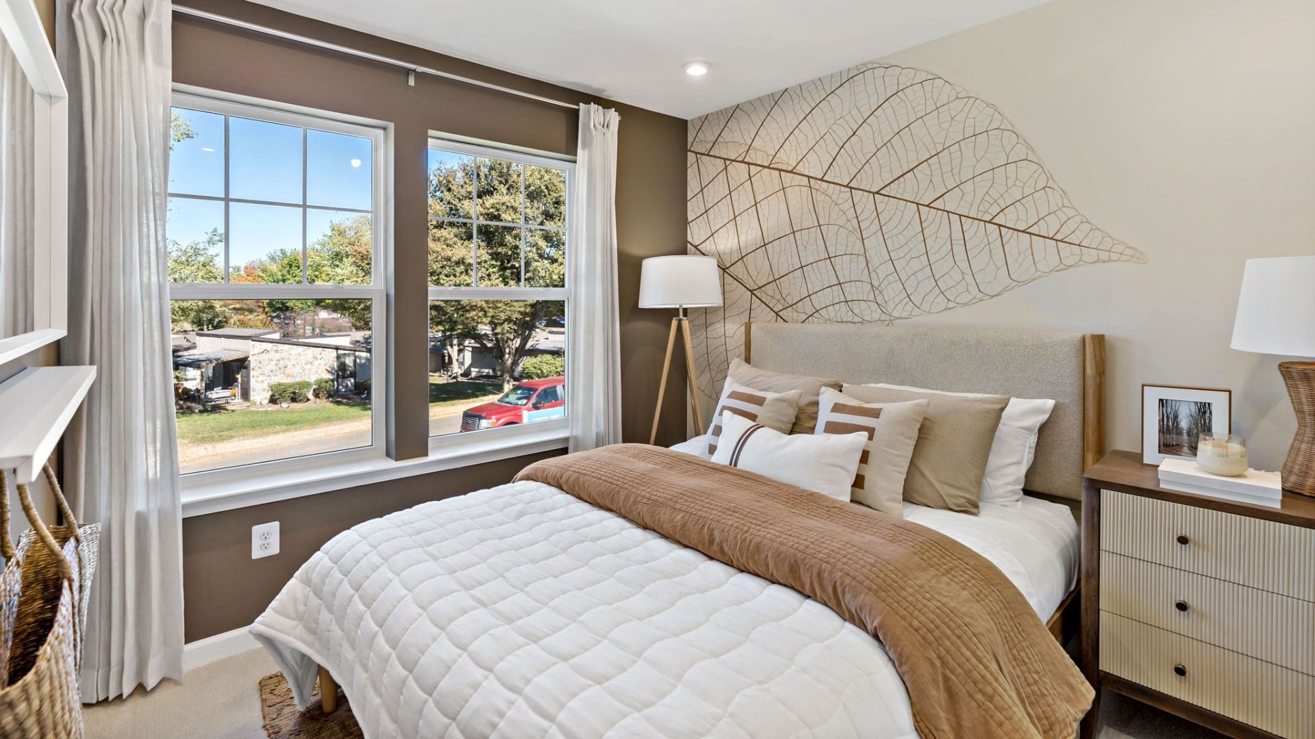 Third bedroom featuring large windows and inviting, cozy touches.