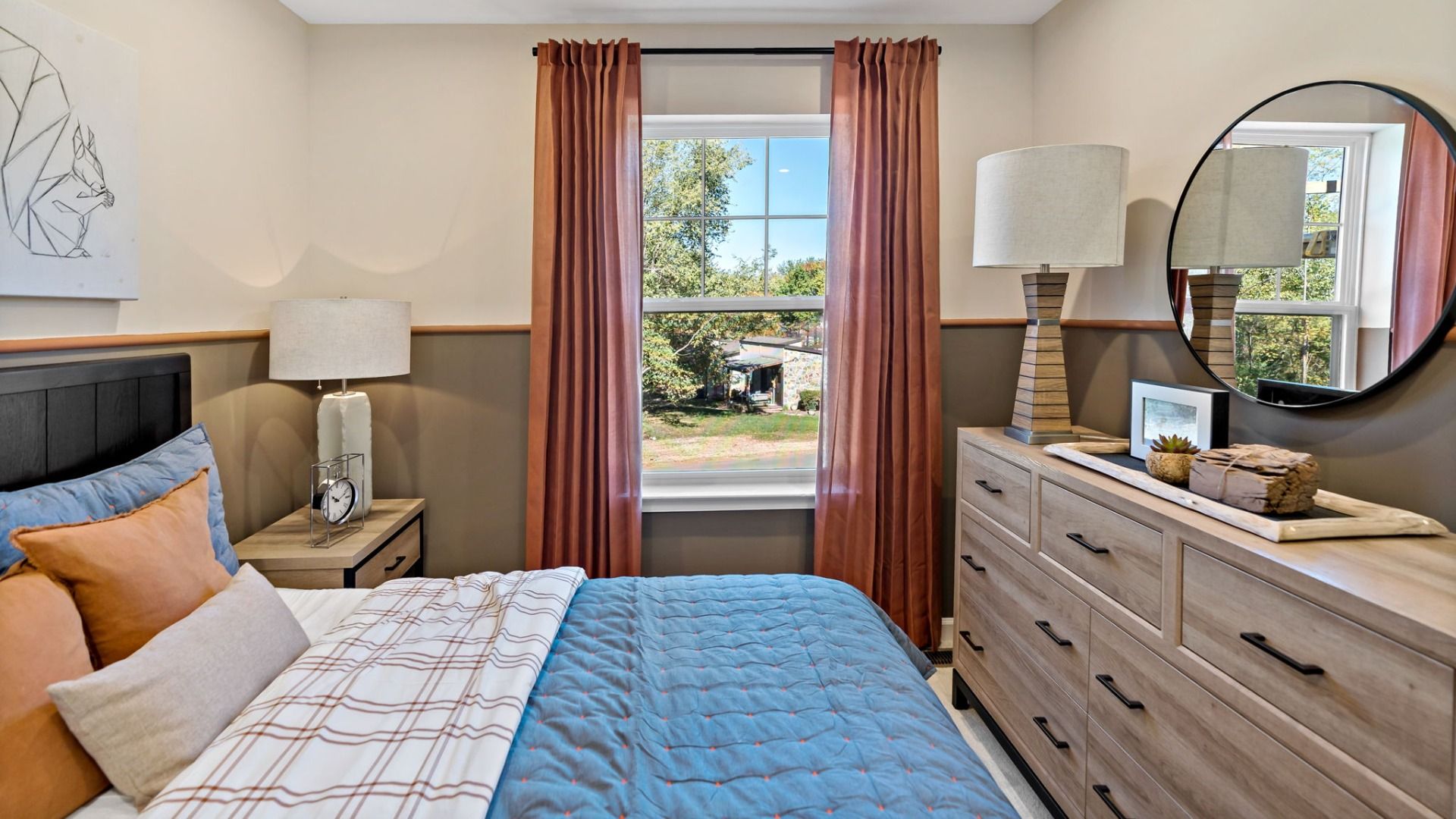 Second bedroom in the Madison II floor plan featuring a window view and space for a dresser.