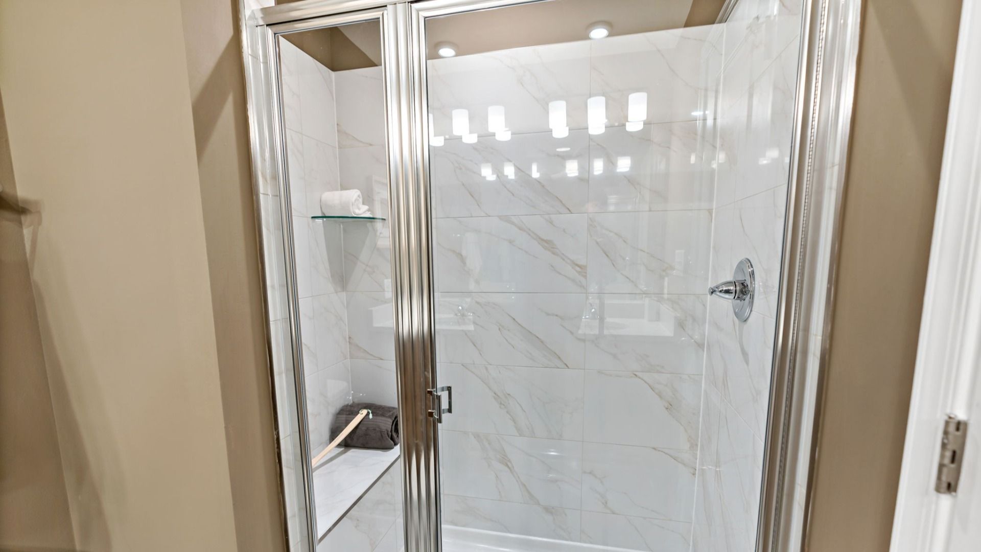 Owners bathroom with a stone shower and metal accents for a sleek, modern touch.
