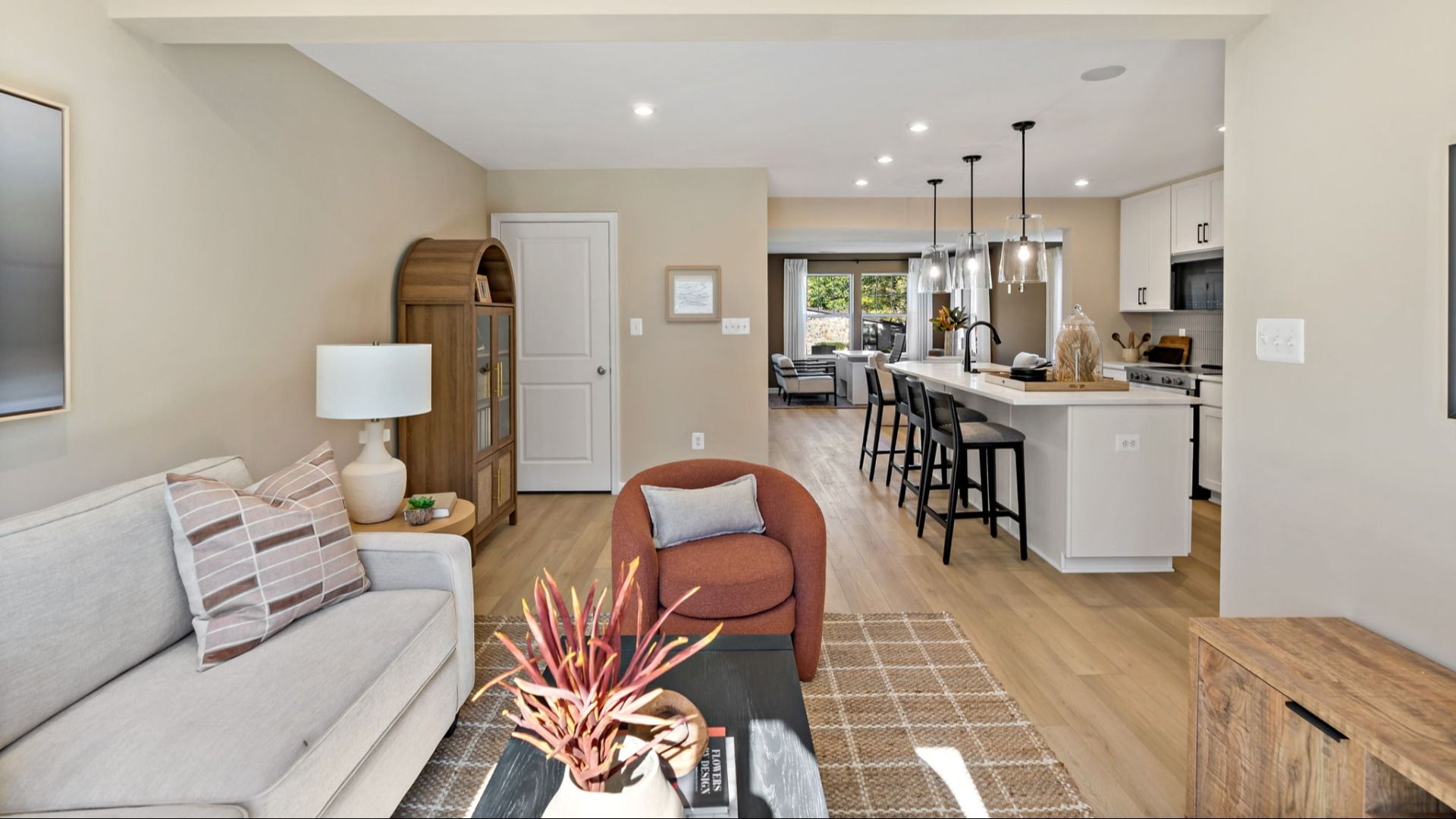 The open-concept first floor features a kitchen and living area with cozy accents.