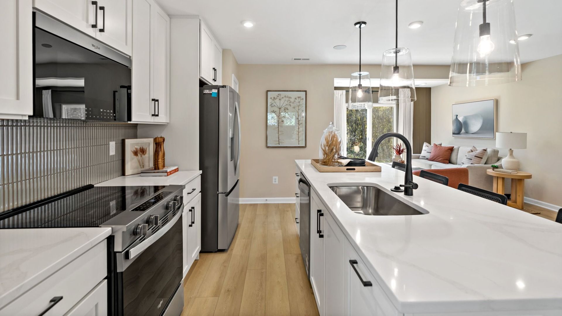 Cook and prep with ease in this kitchen featuring stainless steel appliances and an island sink.