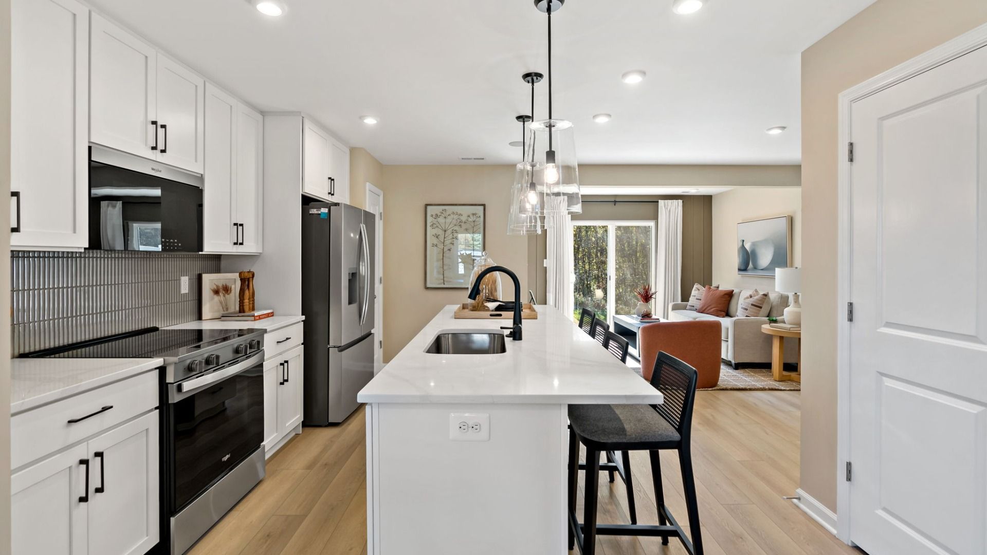 Spacious kitchen featuring a large center island and bright furnishings.