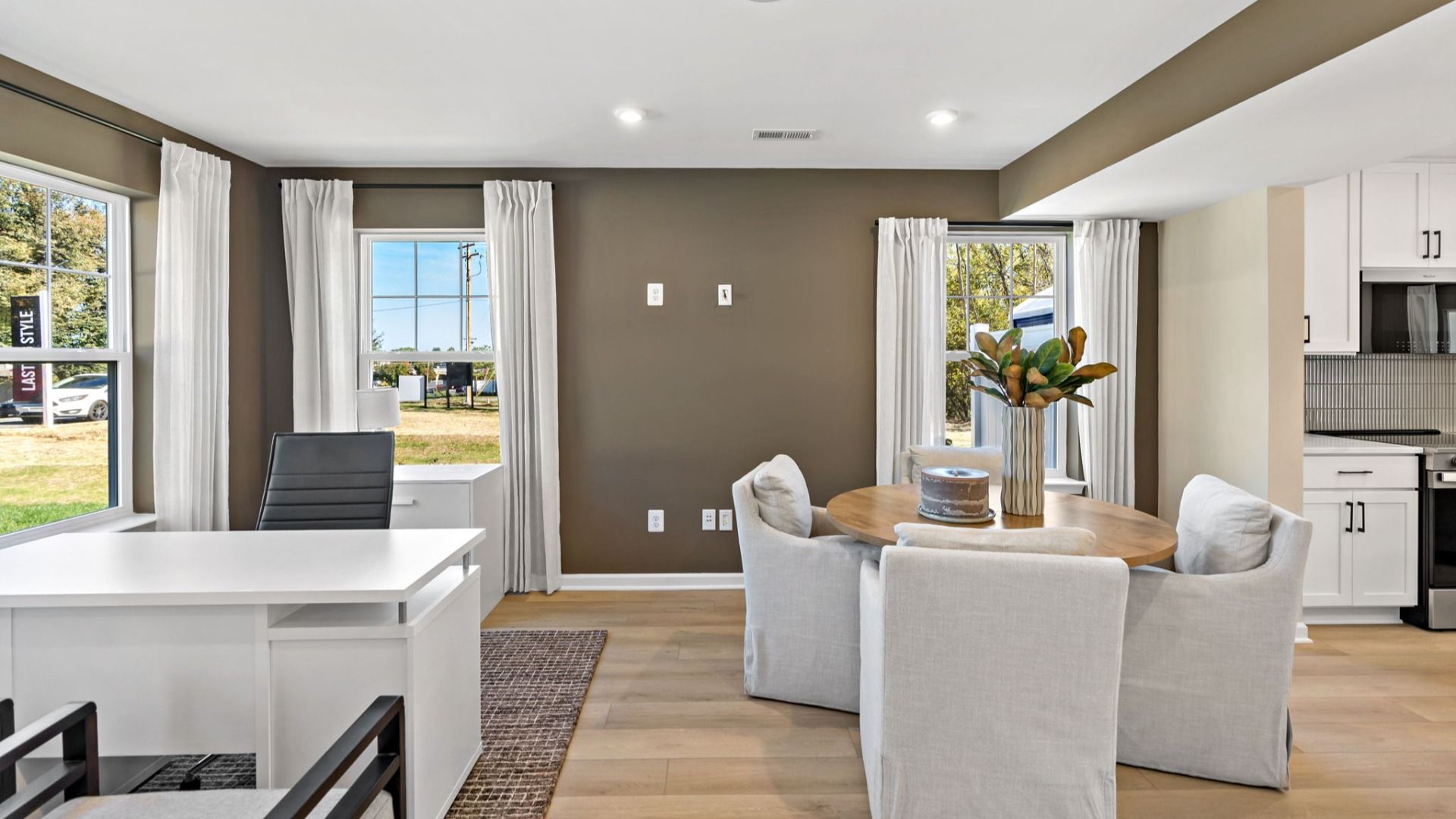 Bright dining and office space with natural light, perfect for work and meals.