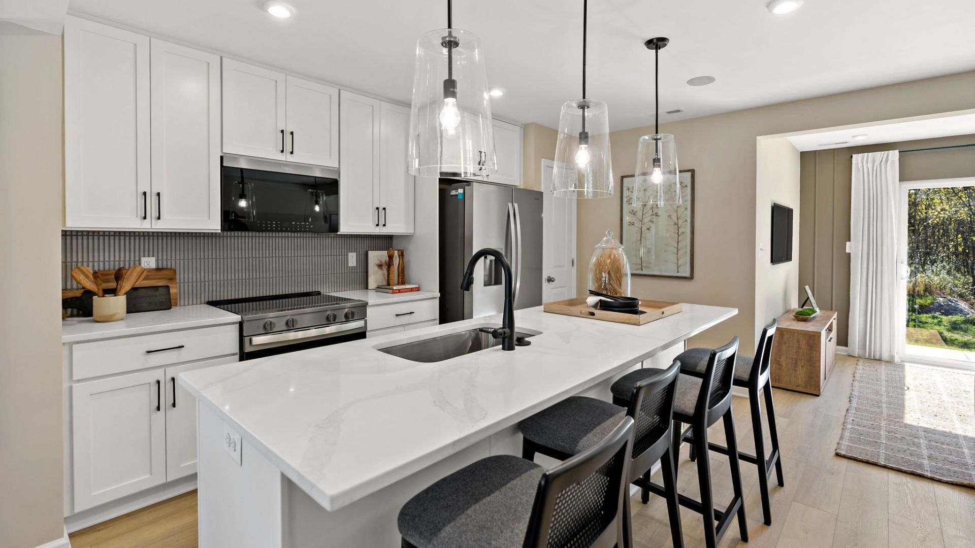 Enjoy bright finishes, pendant lighting, and island seating in the Madison II kitchen.