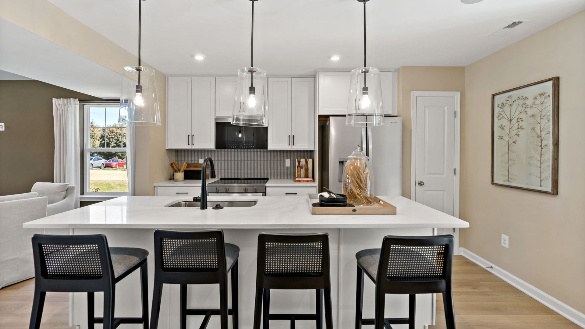 Enjoy cooking and gathering around the kitchen island with modern lighting in the Madison II.